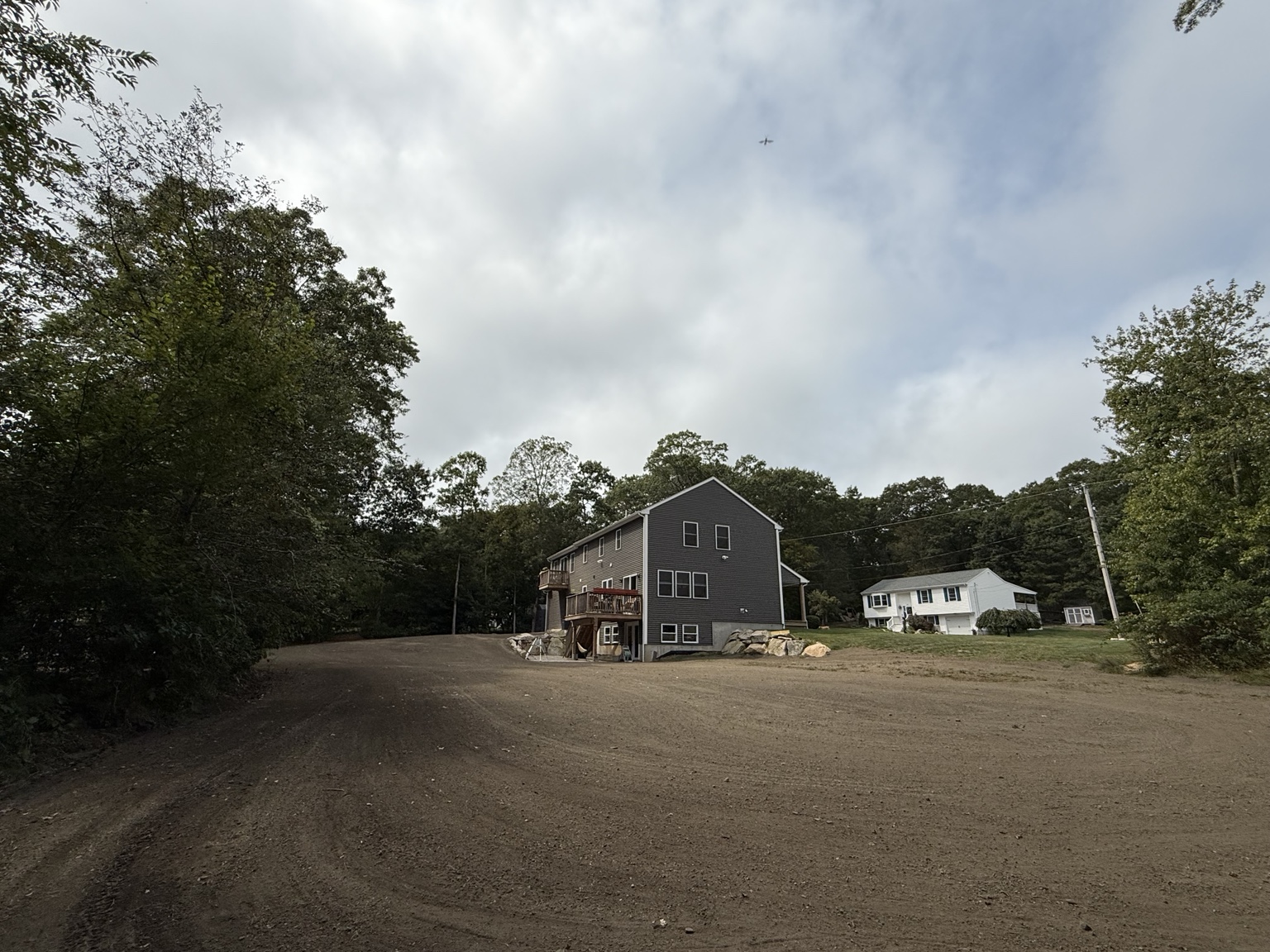 Graded yard and completed site work with home in the distance